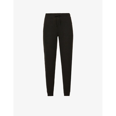 Shop Alo Yoga Soho Mid-rise Stretch-jersey Jogging Bottoms In Black