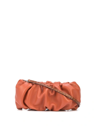 Shop Staud Small Bean Ruched-effect Shoulder Bag In Orange