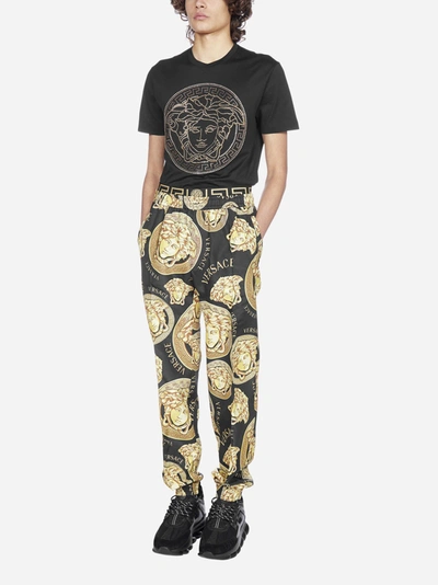 Shop Versace Logo And Medusa Print Track Pants In Black - Gold