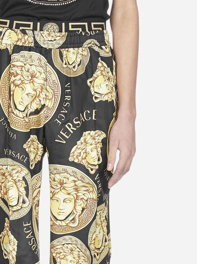 Shop Versace Logo And Medusa Print Track Pants In Black - Gold