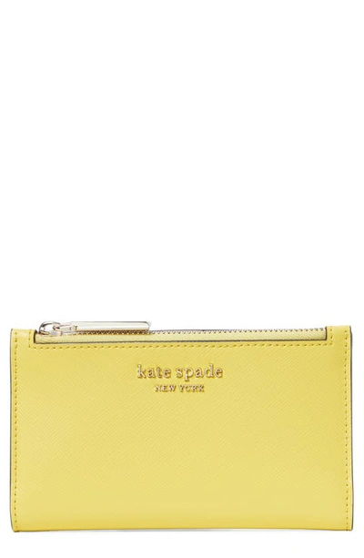 Shop Kate Spade Small Spencer Slim Leather Bifold Wallet In Yellow Sesame