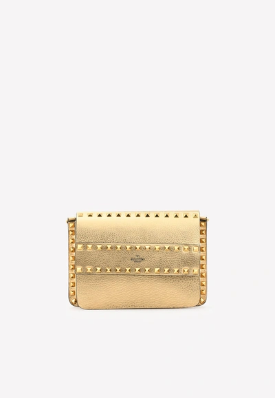 Shop Valentino Small Rockstud Crossbody Bag In Metallic Calfskin In Gold