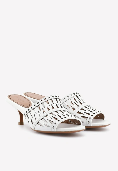 Shop Alaïa 45 Cut-out Mules In Leather In White