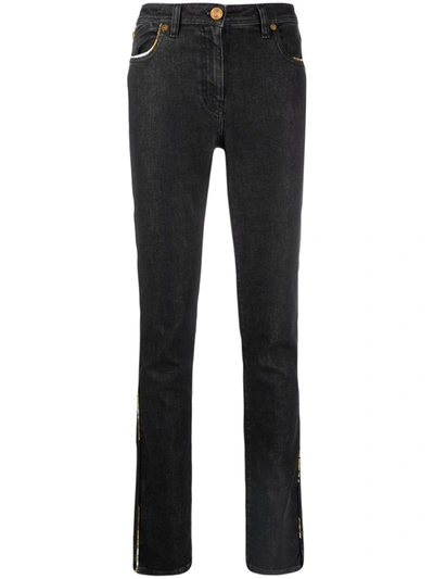 Shop Versace Contrast-trim Slim-fit Jeans In Schwarz