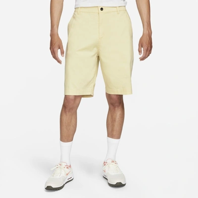 Shop Nike Dri-fit Uv Men's 10.5" Golf Chino Shorts In Lemon Drop