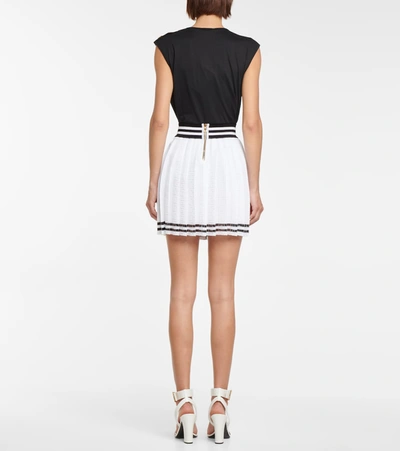 Shop Balmain Pleated Monogram Knit Miniskirt In White