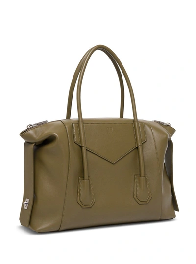 Shop Givenchy Antigona Soft Lock Handbag In Black Leather In Green
