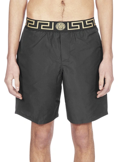 Shop Versace Greca Waistband Swim Shorts In Black