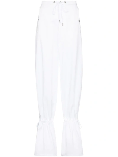 EYELET TIE-CUFF FLARED TROUSERS