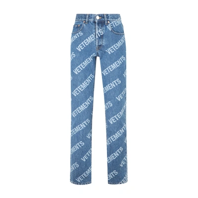 Shop Vetements All Over Logo Magic Fit Denim Jeans In Blue