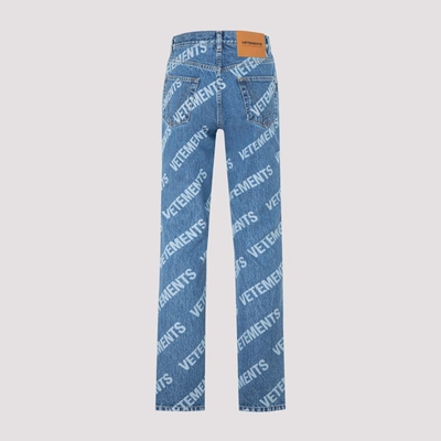 Shop Vetements All Over Logo Magic Fit Denim Jeans In Blue