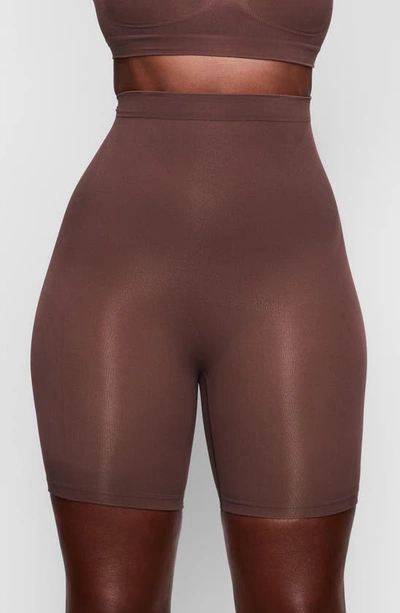 Shop Skims Sculpting Mid Thigh Shorts In Cocoa