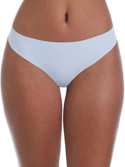 Shop Calvin Klein Invisibles Thong In Polished Blue
