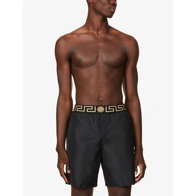 Shop Versace Men's Black Brand-print Straight Swim Shorts