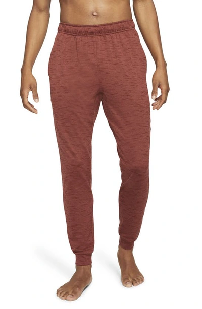 Shop Nike Pocket Yoga Pants In Redstone/bronze Eclipse