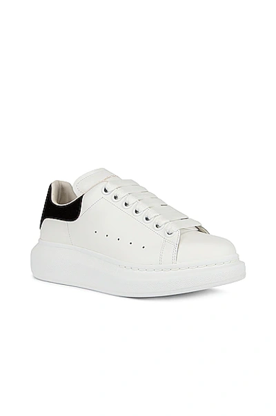 Shop Alexander Mcqueen Lace Up Sneakers In White & Black