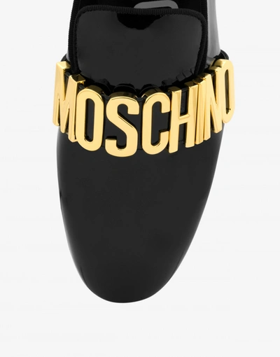 Shop Moschino Metal Lettering Patent Leather Loafers In Black