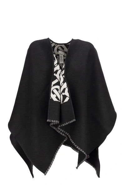 Shop Burberry Solid - Wool Cape With Jacquard Monogram Pattern In Black