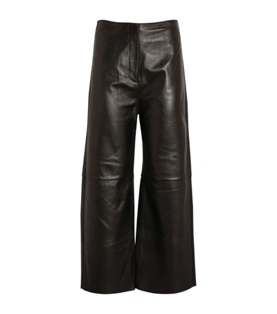 Shop Totême Leather Wide-fit Trousers In Black