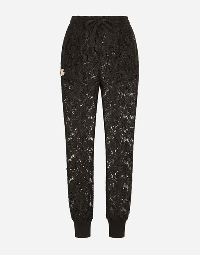 Shop Dolce & Gabbana Macramé Jogging Pants With Crystal Dg Embellishment In Black