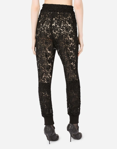 Shop Dolce & Gabbana Macramé Jogging Pants With Crystal Dg Embellishment In Black