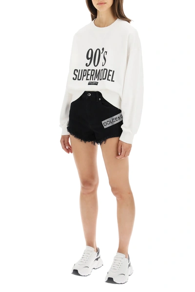 Shop Dolce & Gabbana Denim Shorts With Crystal Logo In Black