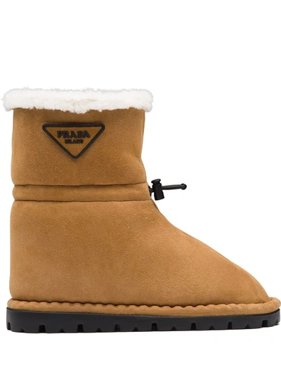 Shop Prada Shearling-lined Logo Plaque Ankle Boots In Braun