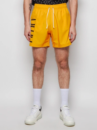 Shop Amiri Vertical Logo Swim Trunks Gold Yellow