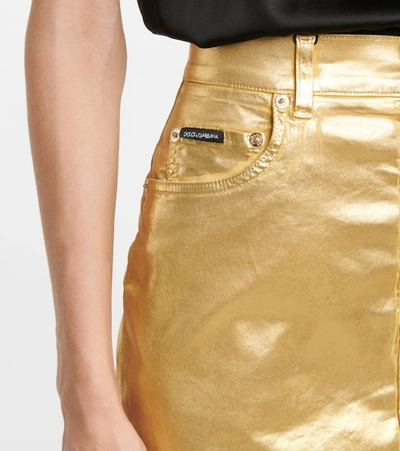 Shop Dolce & Gabbana Coated Denim Miniskirt In Gold