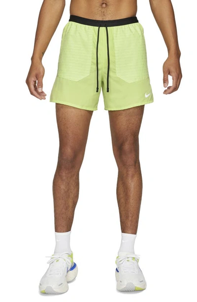 Shop Nike Frame Pleated Belted Leather Shorts In Light Lemon Twist