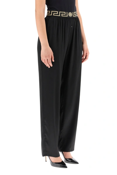 Shop Versace Silk Satin Pajama Trousers With Greca Band In Black,gold