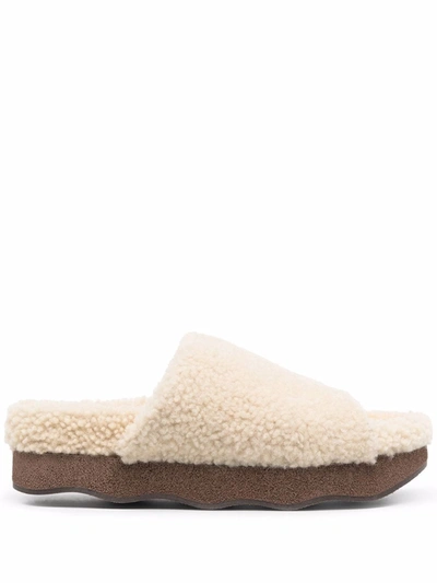 Shop Chloé Wavy Shearling Slides In Nude