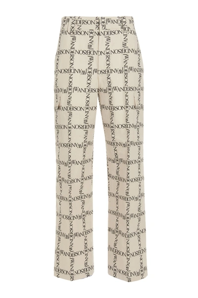 Shop Jw Anderson Allover Logo Printed Trousers In White