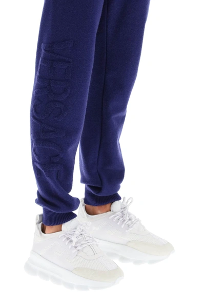 Shop Versace Jogger Pants With Embossed Logo In Purple
