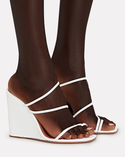 Shop Amina Muaddi Naima Strappy Leather Wedge Sandals In White