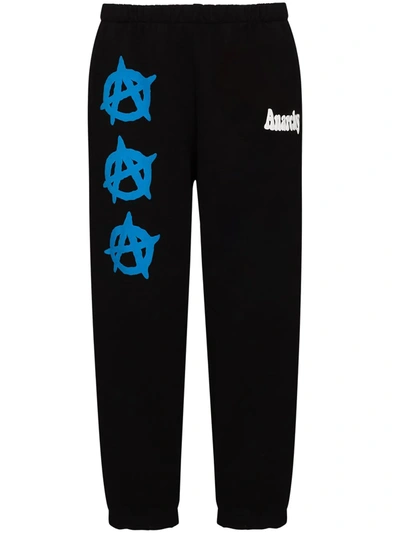 Shop Natasha Zinko Anarchy-print Track Pants In Black