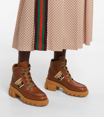 Shop Gucci Gg Leather Ankle Boots In Brown