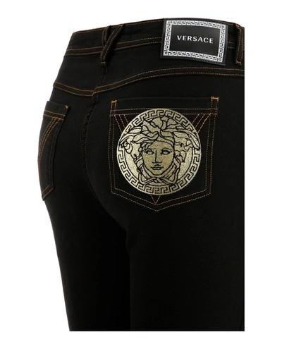 Shop Versace Medusa-patch Skinny Jeans In Black