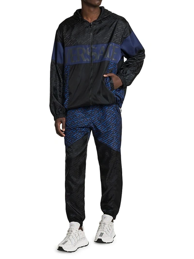 Shop Versace Men's Tech Monogram Print Track Pants In Black Blue