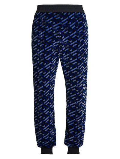 Shop Versace Jersey Jacquard Monogram Print Track Pants In Blue Black