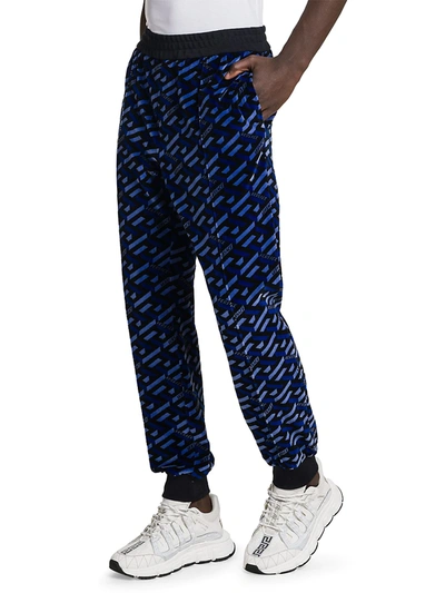 Shop Versace Jersey Jacquard Monogram Print Track Pants In Blue Black