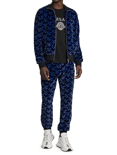 Shop Versace Jersey Jacquard Monogram Print Track Pants In Blue Black