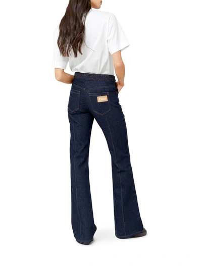 Shop Chloé Bootcut Style Flared Jeans In Recycled Stretch Denim With Weave At The Waist In Blue
