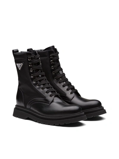 Prada Logo-plaque Panelled Ankle Boots In Black