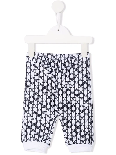 Shop Balmain Monogram Print Track Pants In White