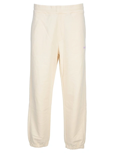 Shop Msgm Solid Colour Joggers With Logo Print In Cream