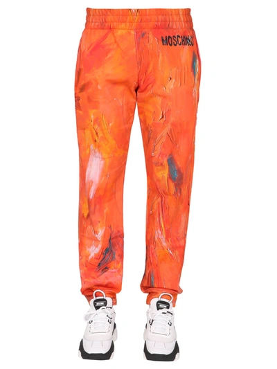 Shop Moschino Painting Jogging Pants In Arancione