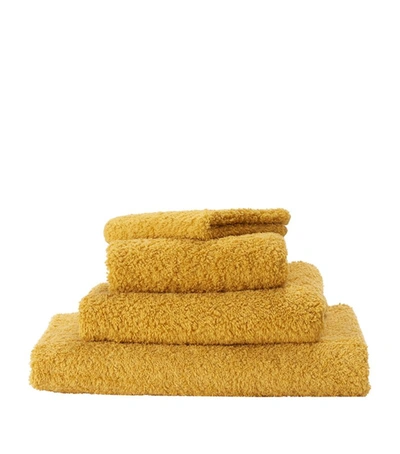 Shop Abyss & Habidecor Super Pile Hand Towel (55cm X 100cm) In Gold