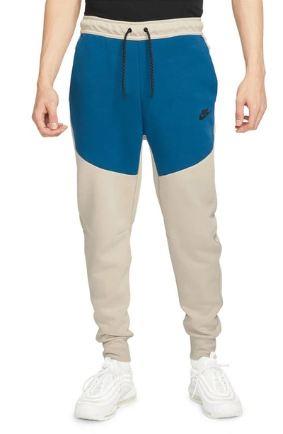 Shop Nike Tech Fleece Jogger Sweatpants In Cream Ii/ Court Blue/ Black