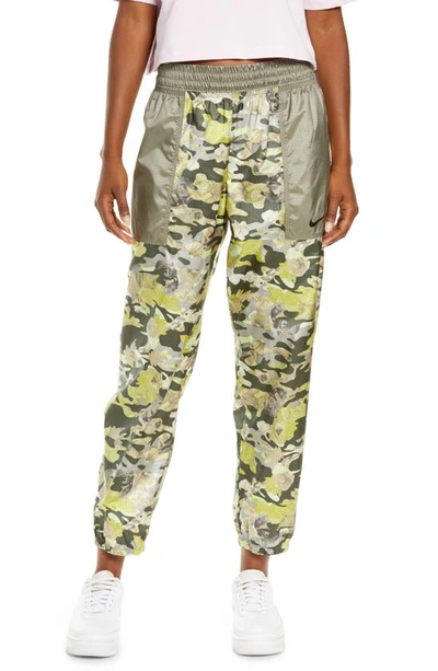 Shop Nike Sportswear Floral Track Pants In Cargo Khaki/ Light Army/ Black
